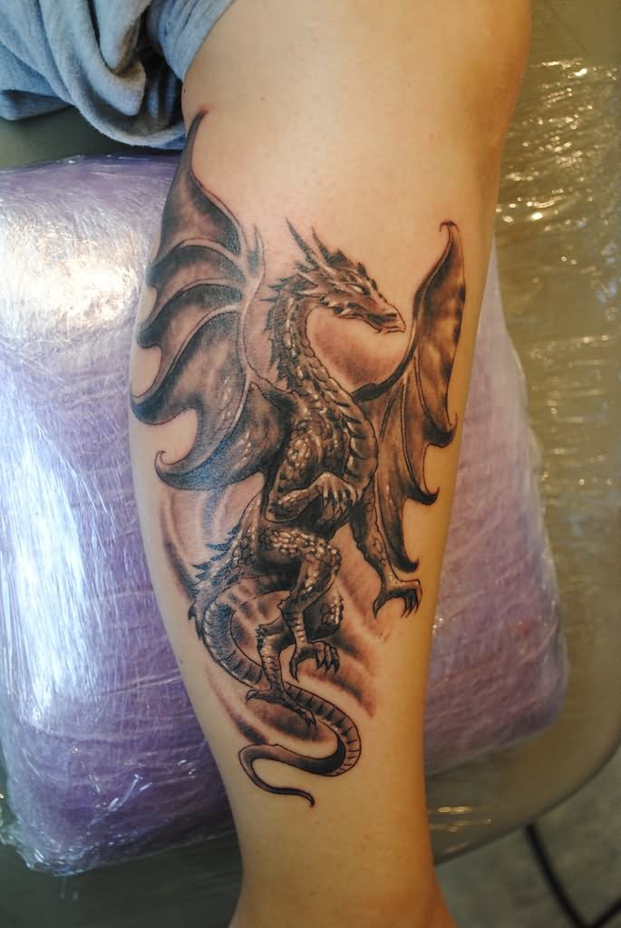 Black Ink Flying Dragon Tattoo On Leg Calf
