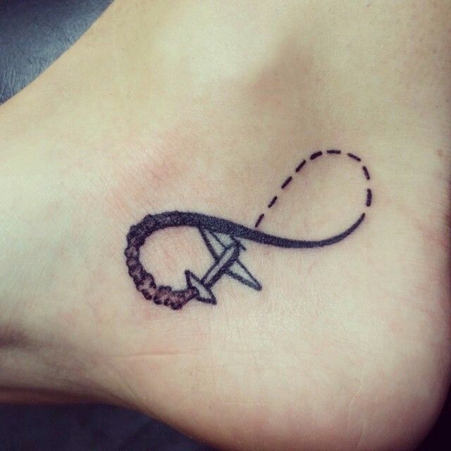 Black Ink Infinity With Airplane Tattoo On Right Ankle
