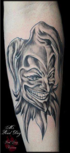 Black Ink Jester Head Tattoo On Sleeve
