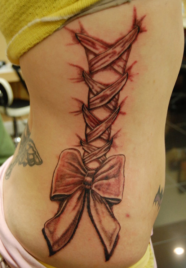 Black Ink Lace Corset With Bow Tattoo On Right Side Rib By Sean