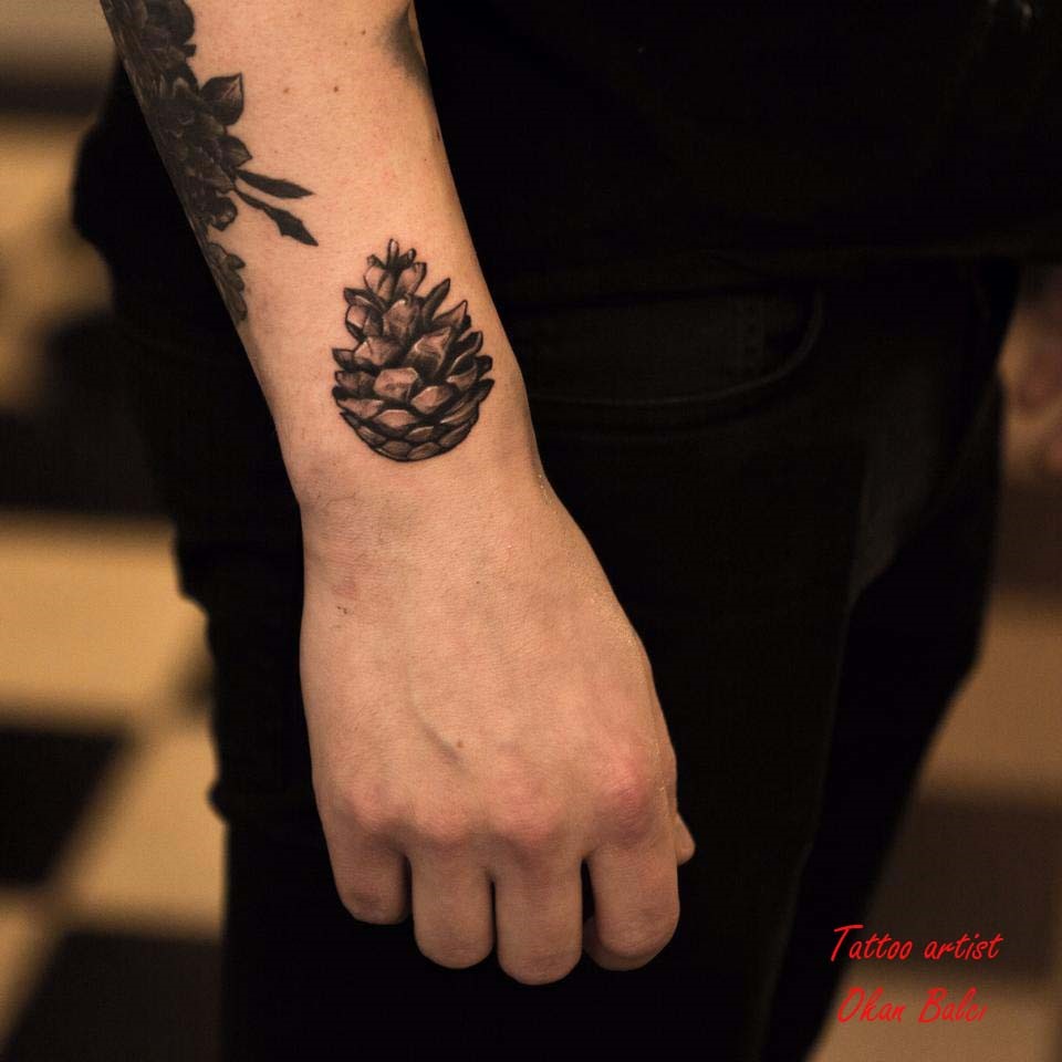Black Ink Pine Cone Tattoo On Right Upper Wrist