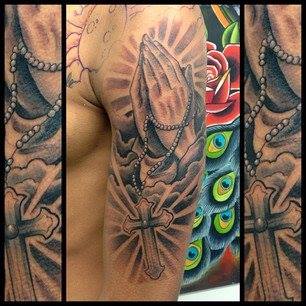 Black Ink Praying Hands With Rosary Cross Tattoo On Man Left Half Sleeve
