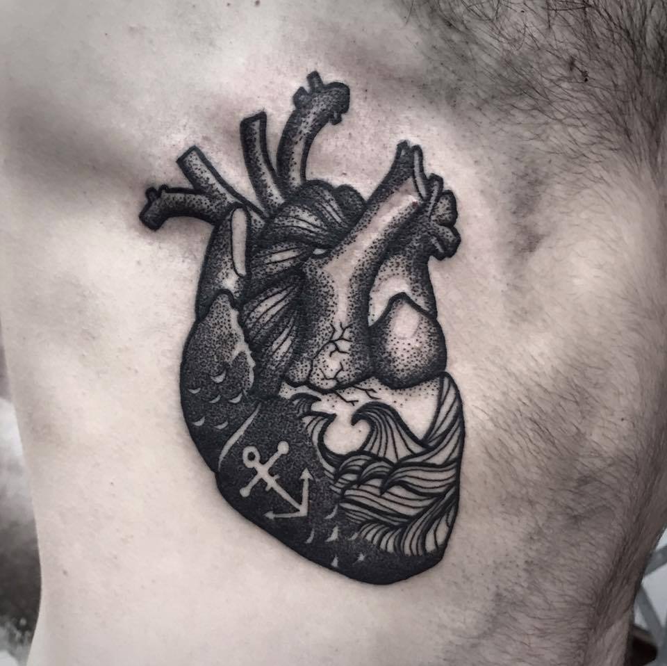 Black Ink Real Heart Tattoo On Man Right Side Rib By Filipa Vargas