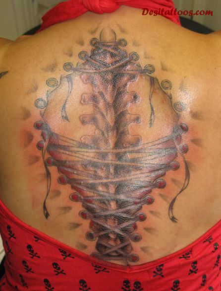 Black Ink Ripped Skin Corset Tattoo On Women Upper Back