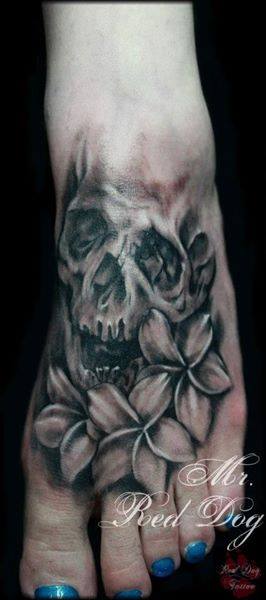 Black Ink Skull With Flowers Tattoo On Left Foot