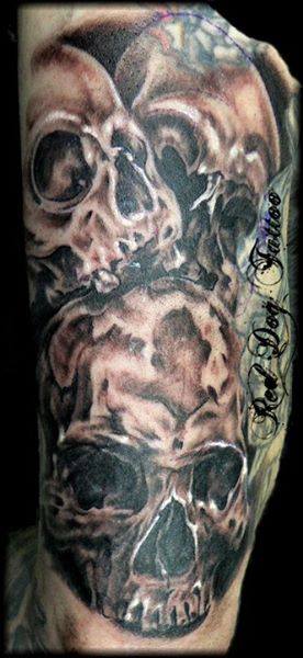 Black Ink Skulls Tattoo On Half Sleeve