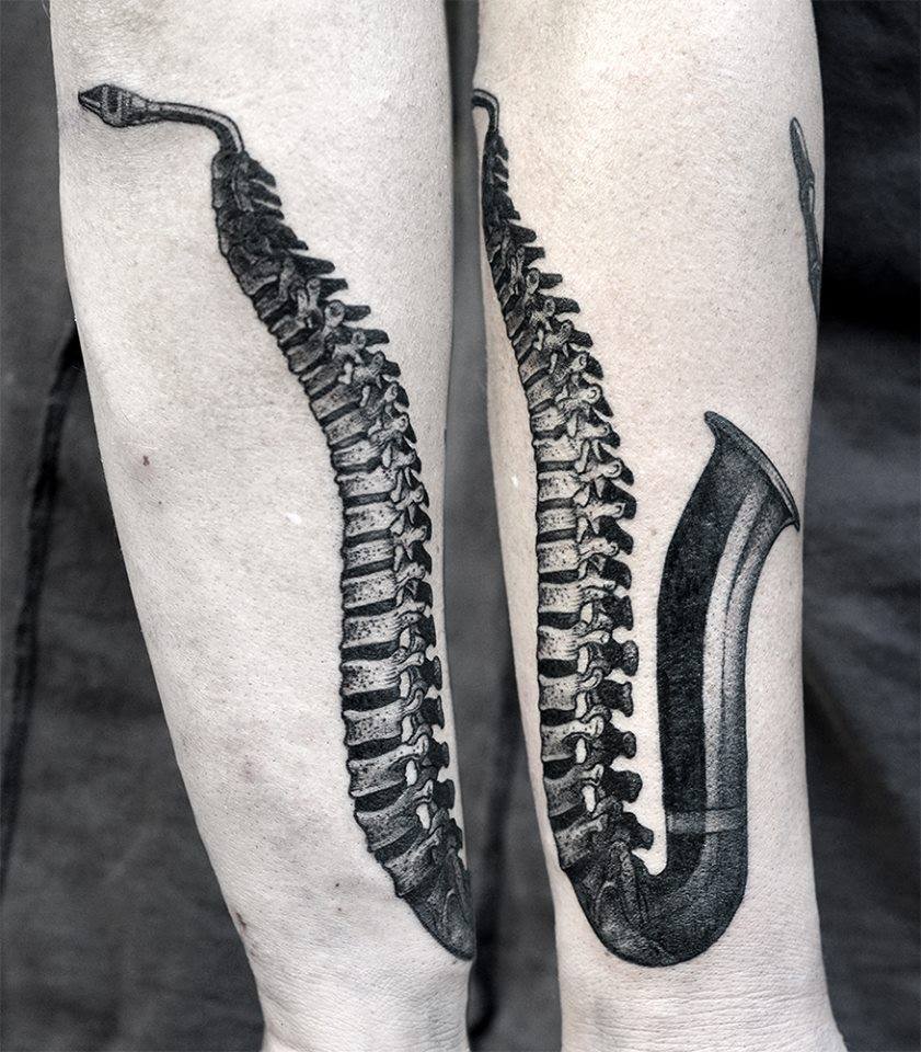 Black Ink Spine Saxophone Tattoo On Right Arm