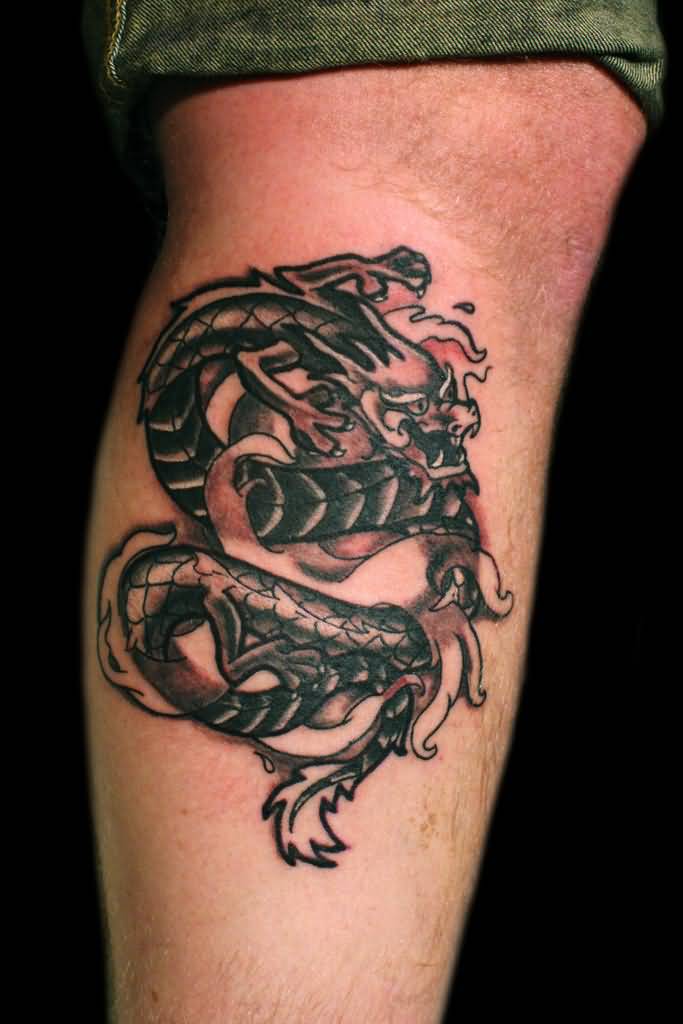 Black Ink Tribal Dragon Tattoo Design For Leg Calf