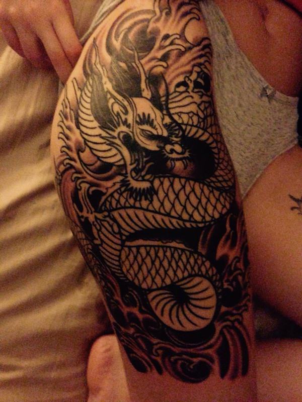 Black Ink Tribal Dragon Tattoo On Right Thigh