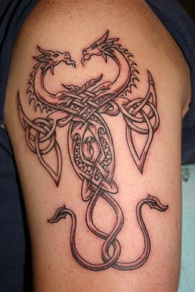 Black Ink Two Celtic Dragons Tattoo On Left Half Sleeve