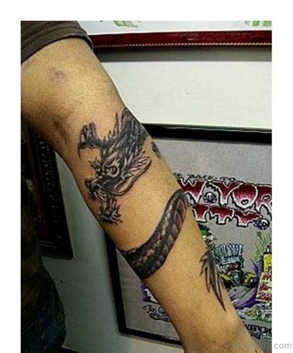 Black Ink Wrap Around Dragon Tattoo On Left Arm