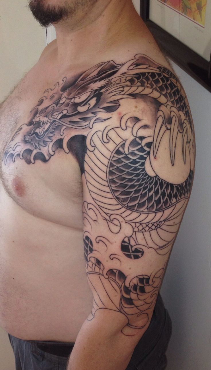 Black Ink Wrap Around Dragon Tattoo On Man Left Half Sleeve