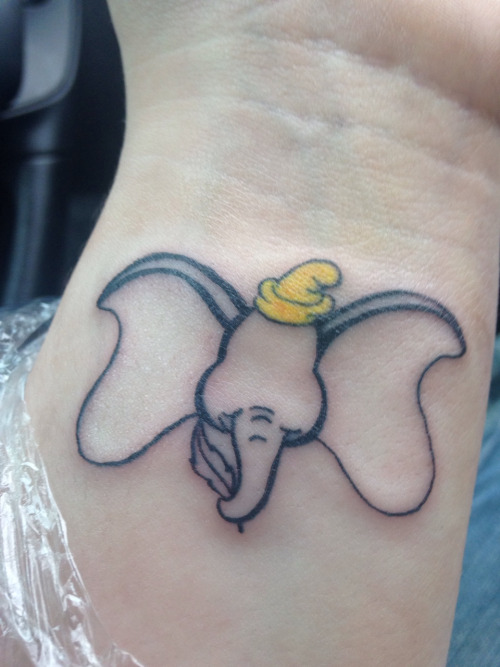 Black Outline Dumbo Tattoo On Left Wrist