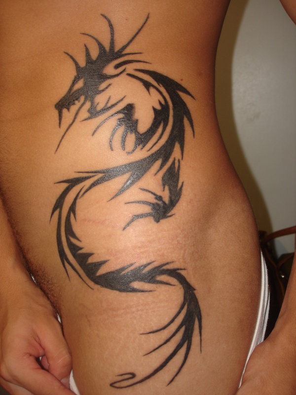 Black Tribal Dragon Tattoo On Women Left Hip