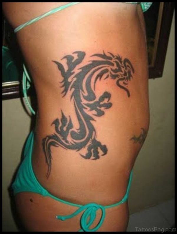 Black Tribal Dragon Tattoo On Women Right Side Rib