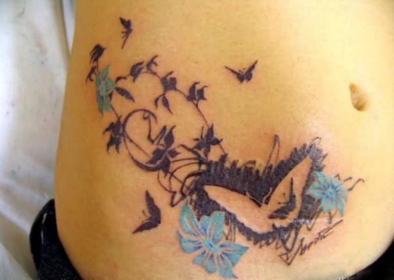 Blue Flowers And Butterfly Tattoo On Lower Back