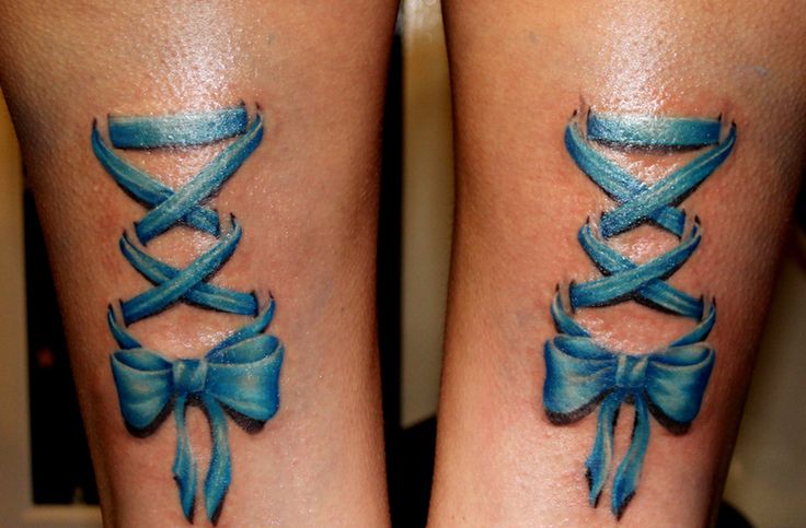 Blue Ink Corset With Bow Tattoo On Both Leg Calf