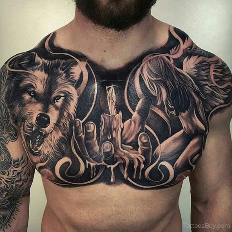 Burning Candle On Hand And Wolf Head Tattoo On Man Chest