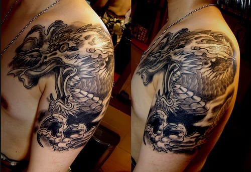 Classic Black Ink Dragon Tattoo On Man Left Shoulder
