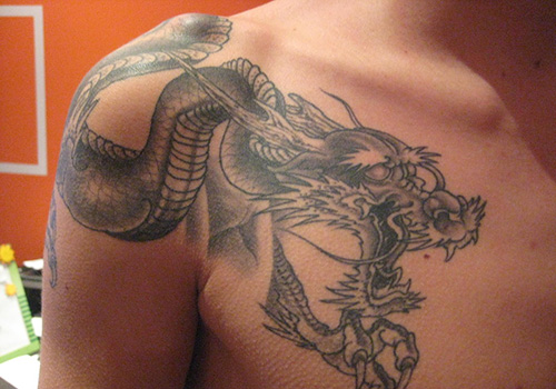 Classic Black Ink Dragon Tattoo On Man Right Shoulder And Chest By Elmoronico