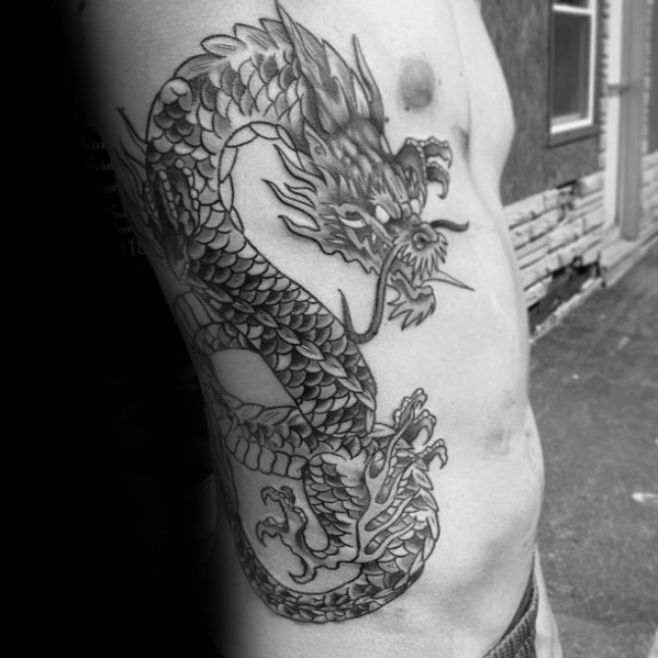 Classic Black Ink Dragon Tattoo On Man Right Side Rib