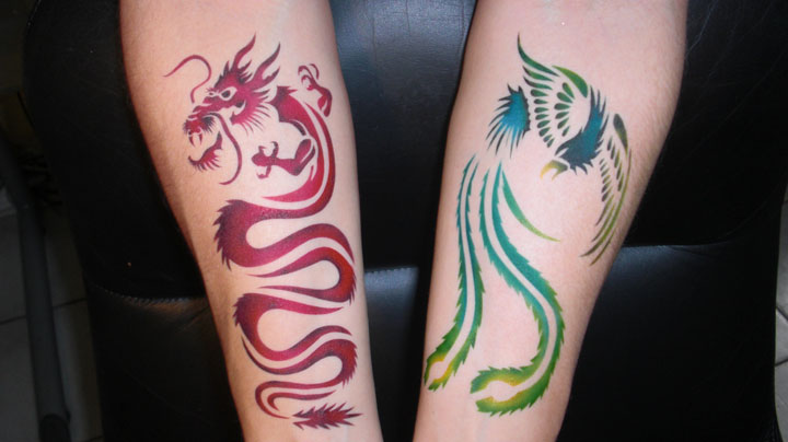 Colorful Airbrush Dragon And Phoenix Tattoo On Both Forearm