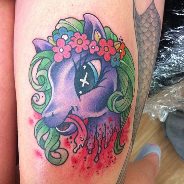 Colorful Cartoon Pony Head Tattoo On Left Thigh