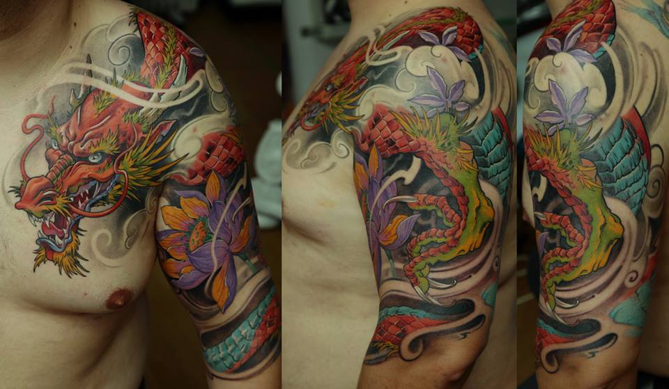 Colorful Dragon With Lotus Flower Tattoo On Man Left Half Sleeve