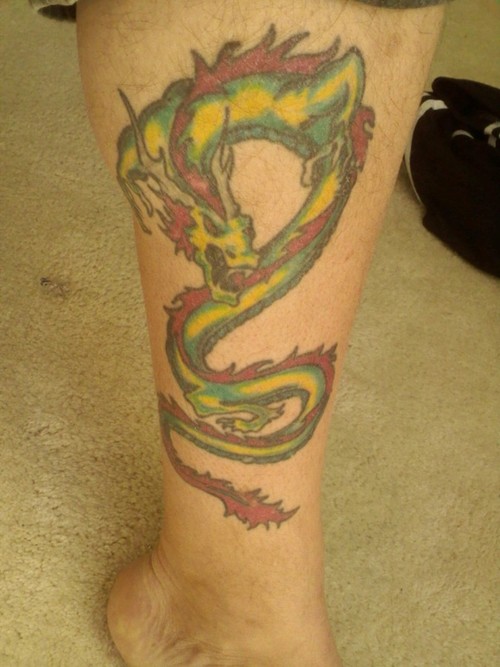 Colorful Dragon Wrap Around Tattoo On Right Leg