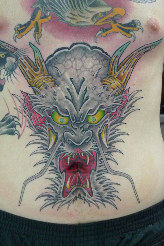 Colorful Traditional Dragon Head Tattoo On Man Stomach