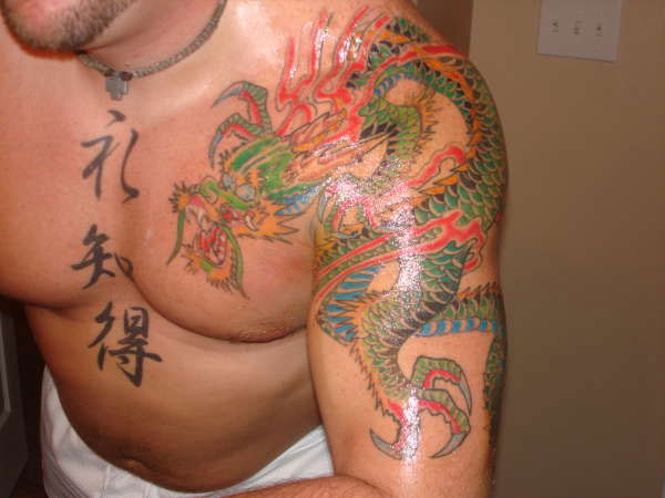 Colorful Traditional Dragon Tattoo On Man Left Shoulder