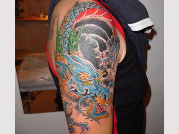 Colorful Traditional Dragon Tattoo On Man Right Shoulder