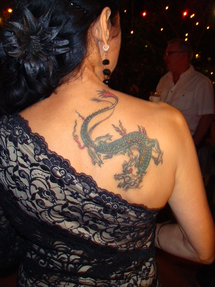 Colorful Traditional Dragon Tattoo On Women Upper Back