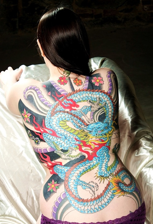 Colorful Traditional Dragon With Flowers Tattoo On Girl Full Back