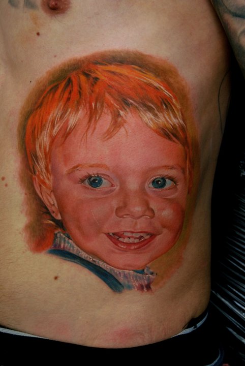 Cool Baby Portrait Tattoo On Man Left Side Rib