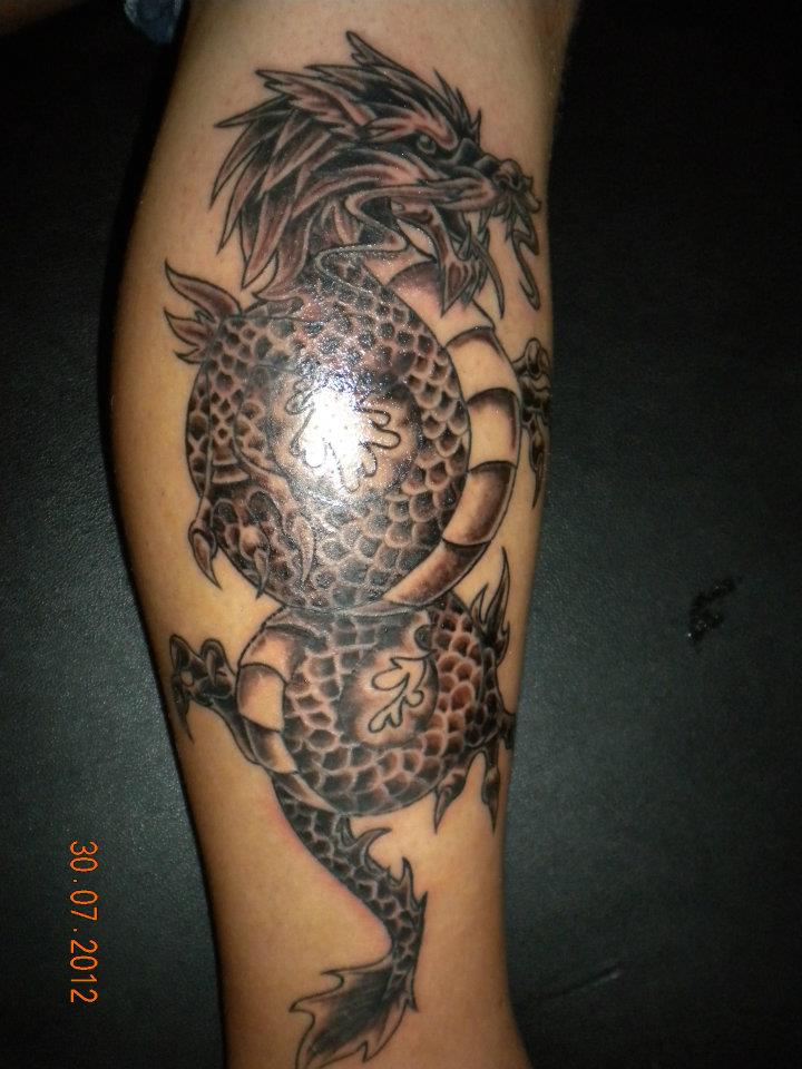 Cool Black Ink Dragon Tattoo On Leg Calf