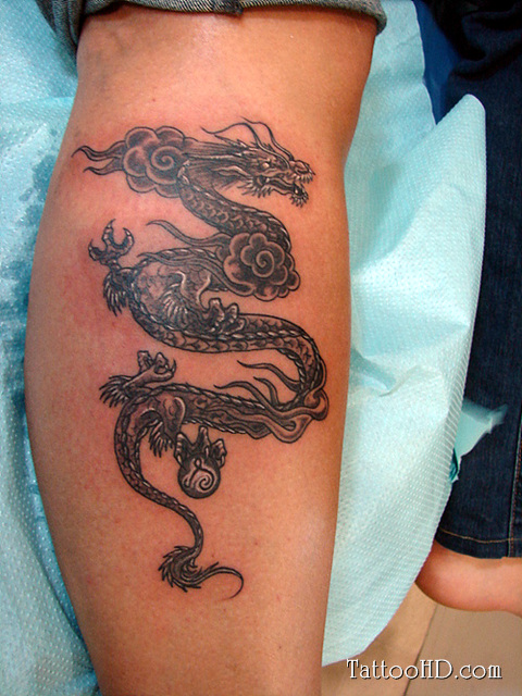 Cool Black Ink Dragon Tattoo On Right Leg Calf