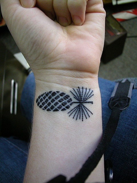 Cool Black Pine Cone Tattoo On Left Wrist