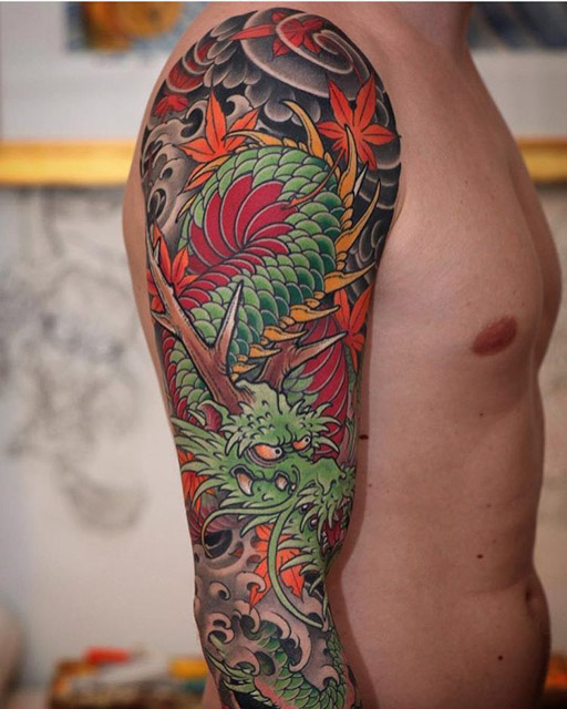 Cool Colorful Traditional Dragon Tattoo On Man Right Sleeve