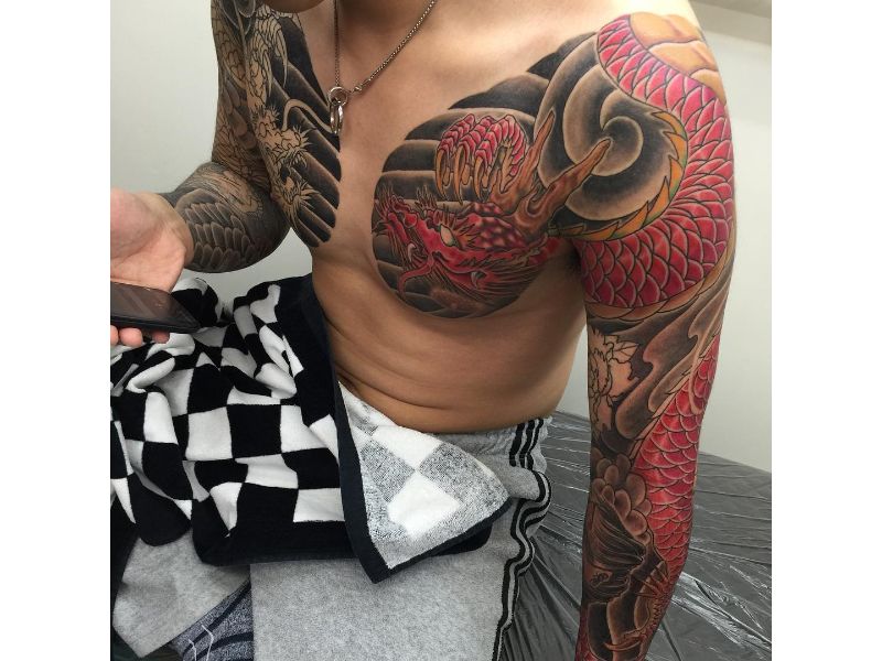 Cool Traditional Dragon Tattoo On Man Left Full Sleeve And Chest