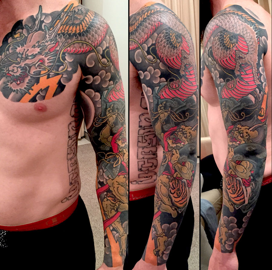 Cool Traditional Dragon Tattoo On Man Left Full Sleeve And Front Shoulder