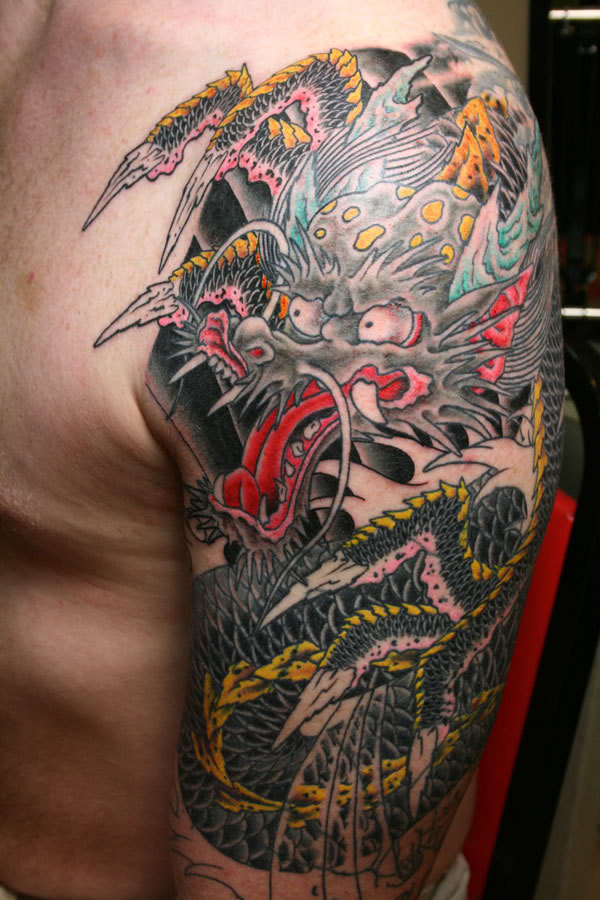 Cool Traditional Dragon Tattoo On Man Left Half Sleeve
