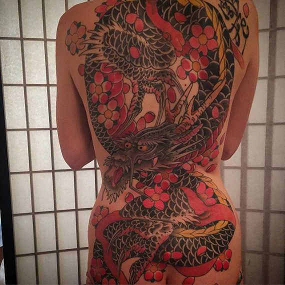 Cool Traditional Dragon With Flowers Tattoo On Full Back