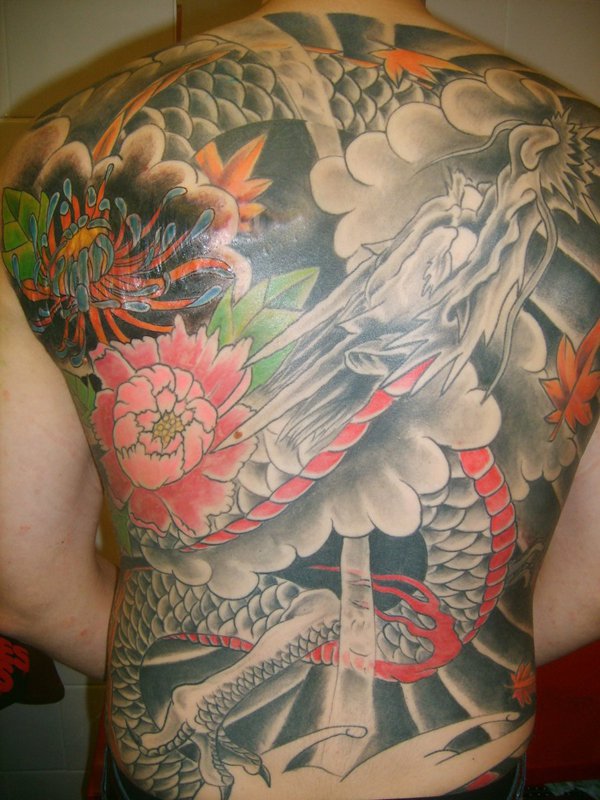 Cool Traditional Dragon With Flowers Tattoo On Man Full Back