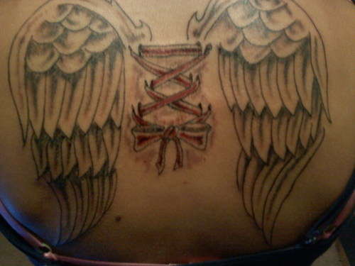 Corset With Bow And Wings Tattoo On Upper Back