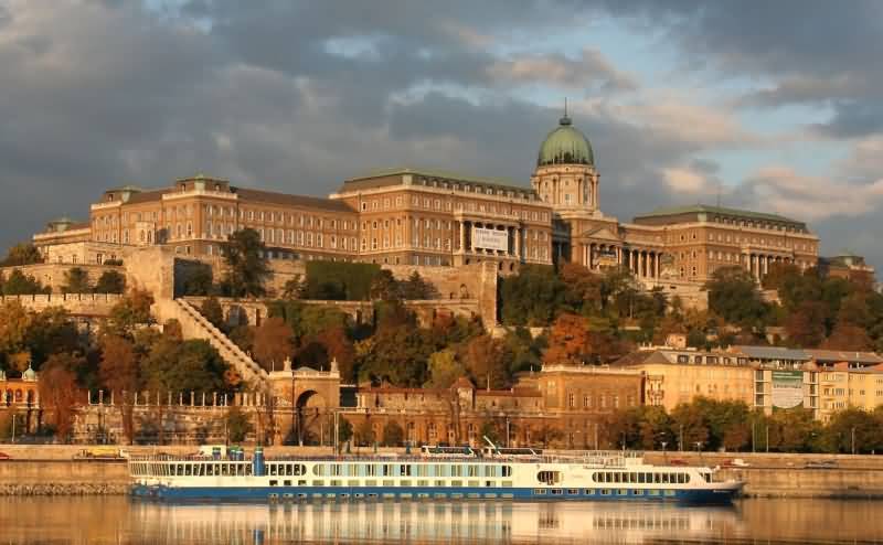Cruise Passing In Front Of The Buda Castle In Danube River