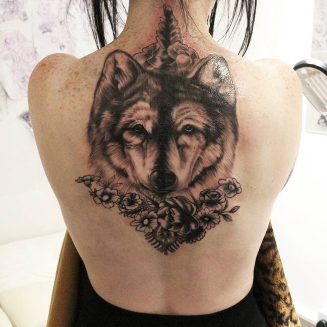 Grey Flowers And Wolf Head Tattoo On Back
