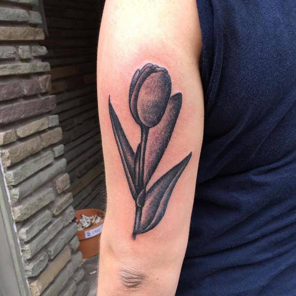 Grey Ink Tulip Tattoo On Bicep