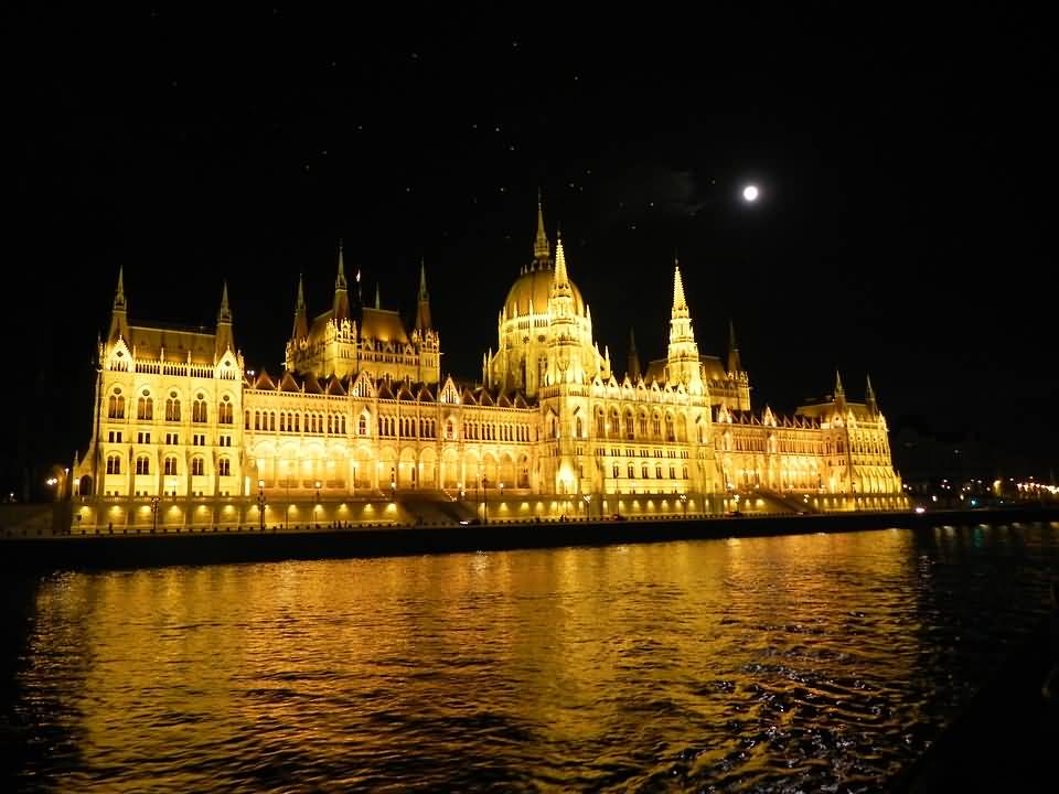 Hungarian Parliament Building With Full Moon At Night