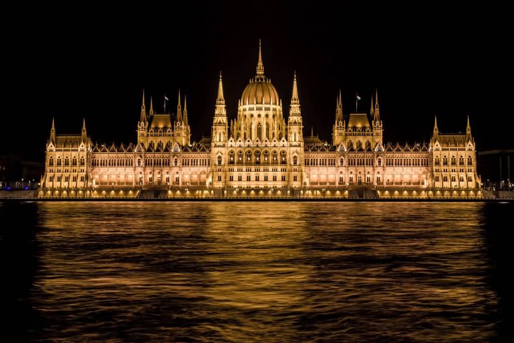 Hungarian Parliament Building With Yellow Lights At Night